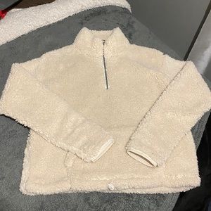 A light cream colored quarter zip sherpa